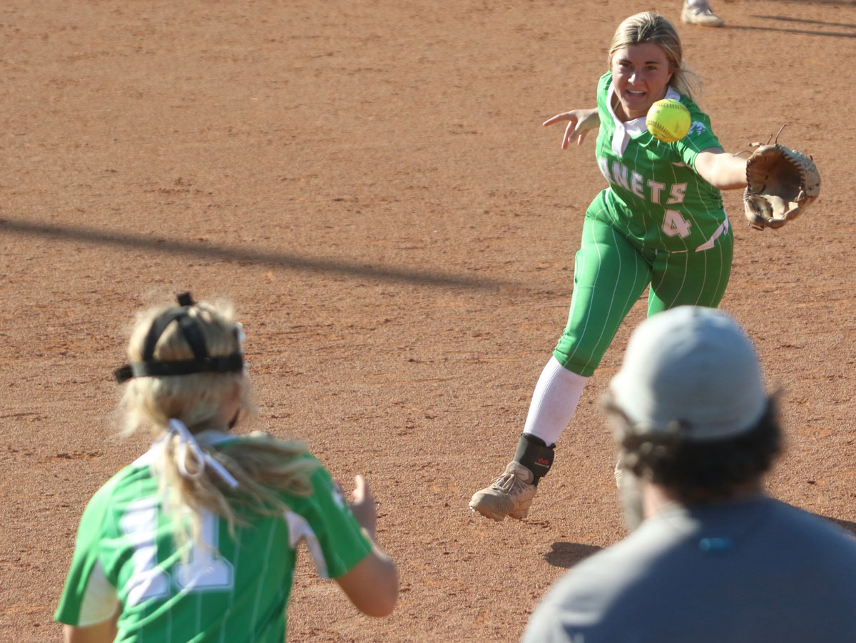 Lakes Kate Gladney flips the ball to first base against Mantachie on Wednesday.
