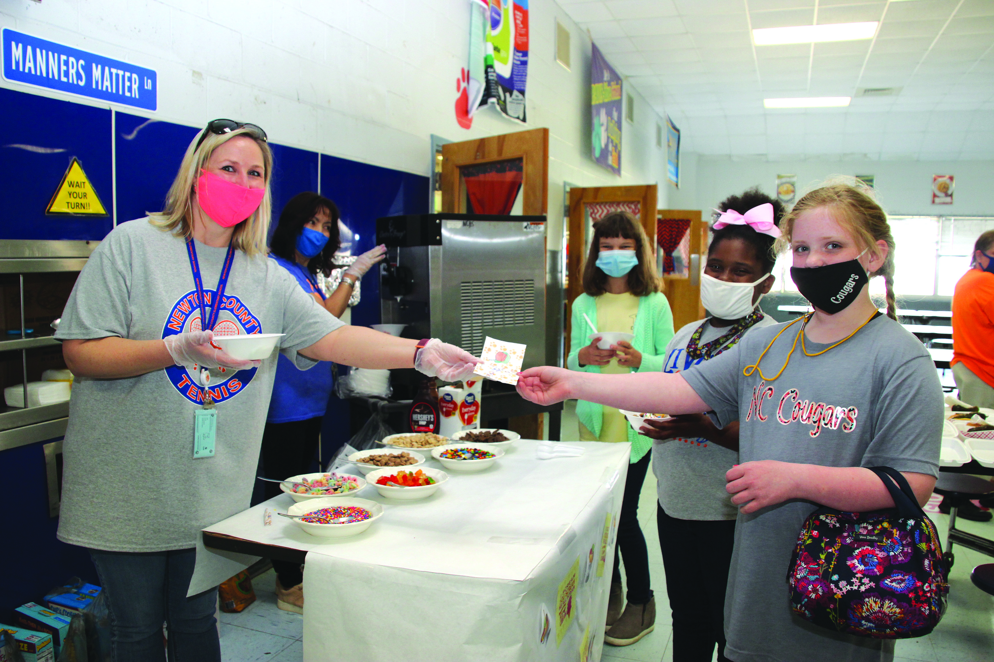 These three fourth graders are all smiles with their selection of the Ice Cream Buffet for their Cougar Buck Reward. Students of Newton County Elementary School were treated to a Cougar Buck Rewards Day on Friday. Each student could choose “to save” for the fourth nine weeks Cougar Rewards Day or “spend” for selections including:  Tattoos, Cap Day, Free Dress Day, Sidewalk Chalk (PreK-2nd grade), Kickball Tournament (3rd-5th grade) or the Ice Cream Buffet from left:  NCES PBIS Chair Sarah Jones, NCES PBIS Team Member Myriam St. Clair, Ashley Federick, Na Kaira Bogan and Bristol Germany. Newton County Elementary School is recognized as a Positive Behavioral Interventions and Supports Model Site in Mississippi.  Submitted photo