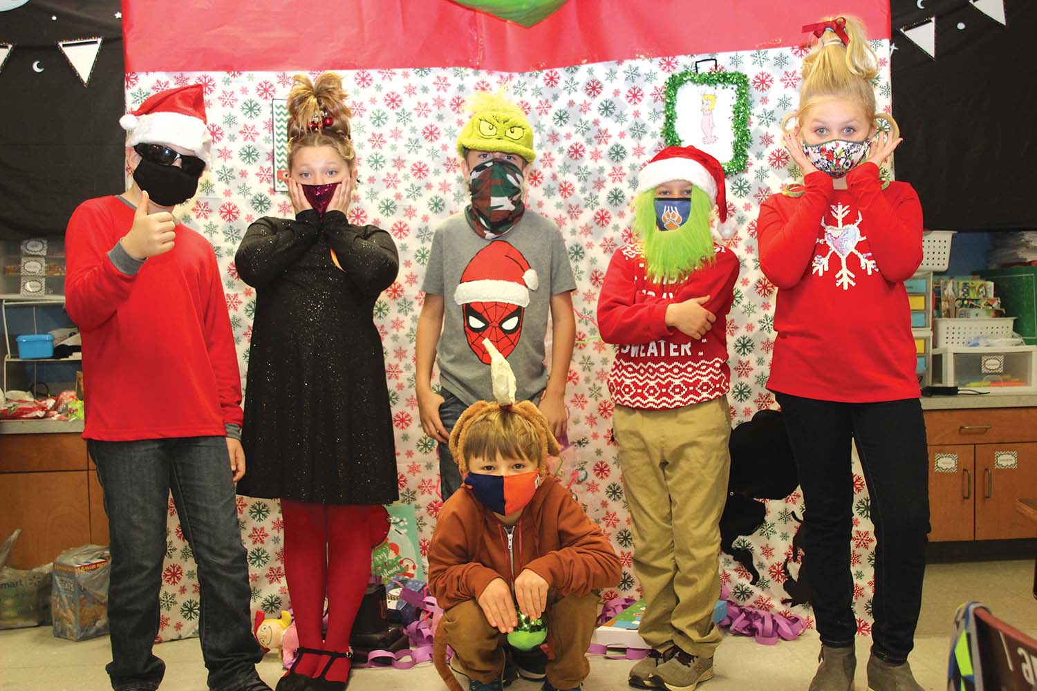 Cindy Thompson’s third graders experienced Christmas this year with a week of discovery through the pen of Dr. Seuss and “How the Grinch Stole Christmas.” With similes and metaphors, observations of character traits in Mr. Grinch, as well as cause and effects in the book, students were challenged with a quote “Then the Grinch thought of something he hadn't before! What if Christmas, he thought, doesn't come from a store? What if Christmas...perhaps...means a little bit more!” The week ended with characters from the book coming to life standing from left:  Brennen McMillan, Emma Ward, Bryce Hughes, Hollis Thompson and Addison Posey with “Max the Dog” aka Jase Roberson.   Submitted photo