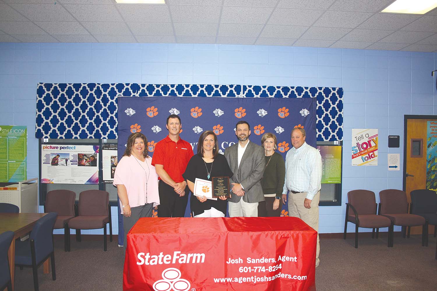 Below: Peoples receives her plaque recognizing her achievement. Pictured are, from left, Assistant Principal Dawn Hollingsworth, State Farm Agent Josh Sanders, Peoples, NCMHS Principal Cody Killen, Assistant Principal Tabitha Chaney and Newton County School Superintendent J.O. Amis.  