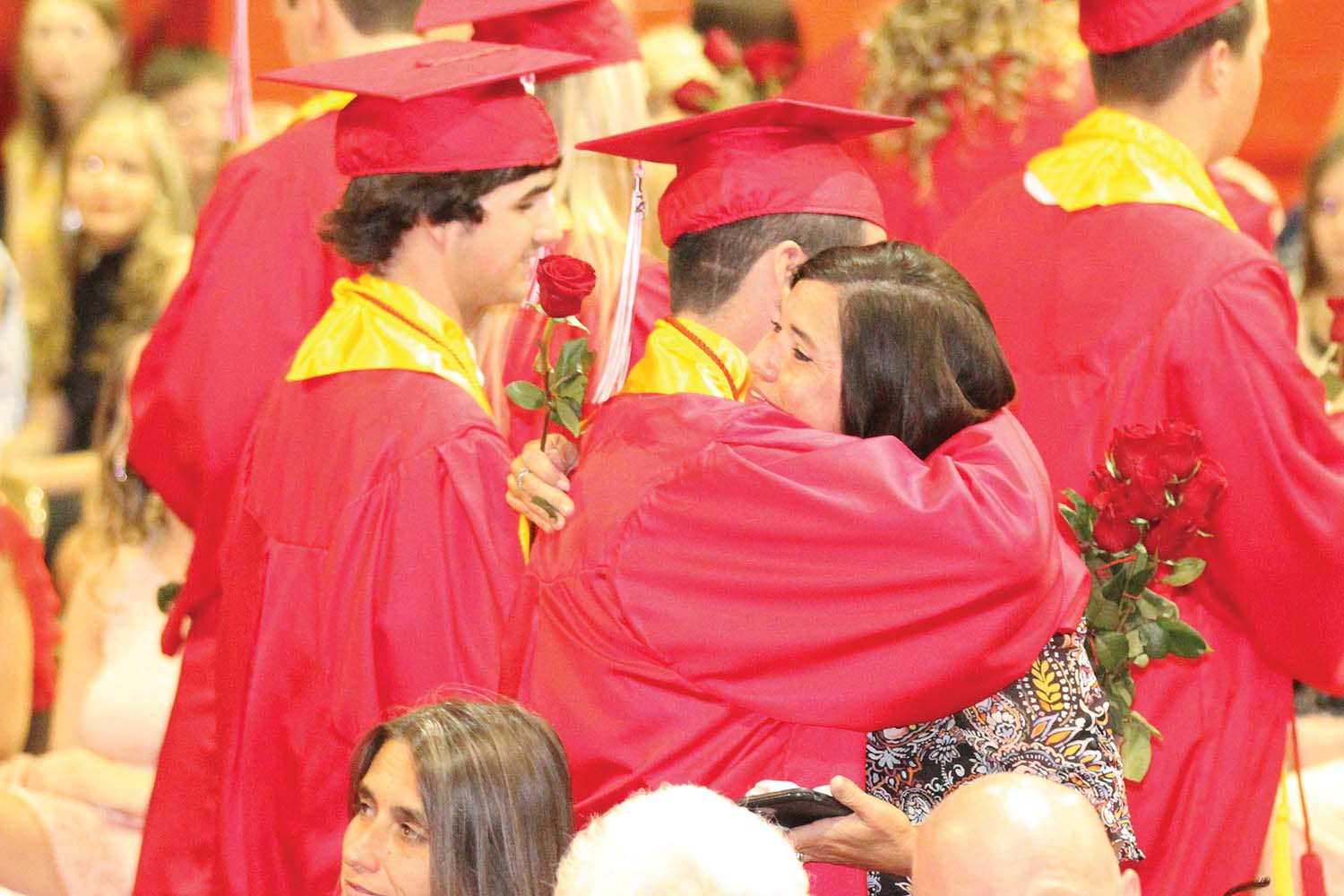 Zandar Meeks presents his mom, Julie, with a rose.