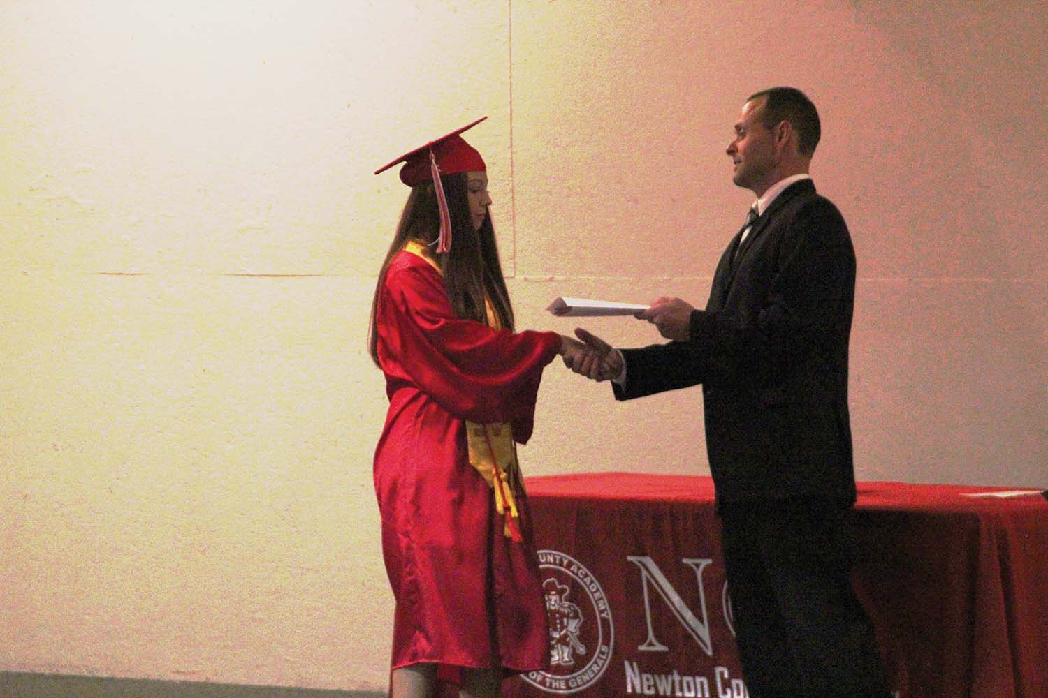 Gracie Humphreys, receives diploma from NCA Board President, Adam Godwin