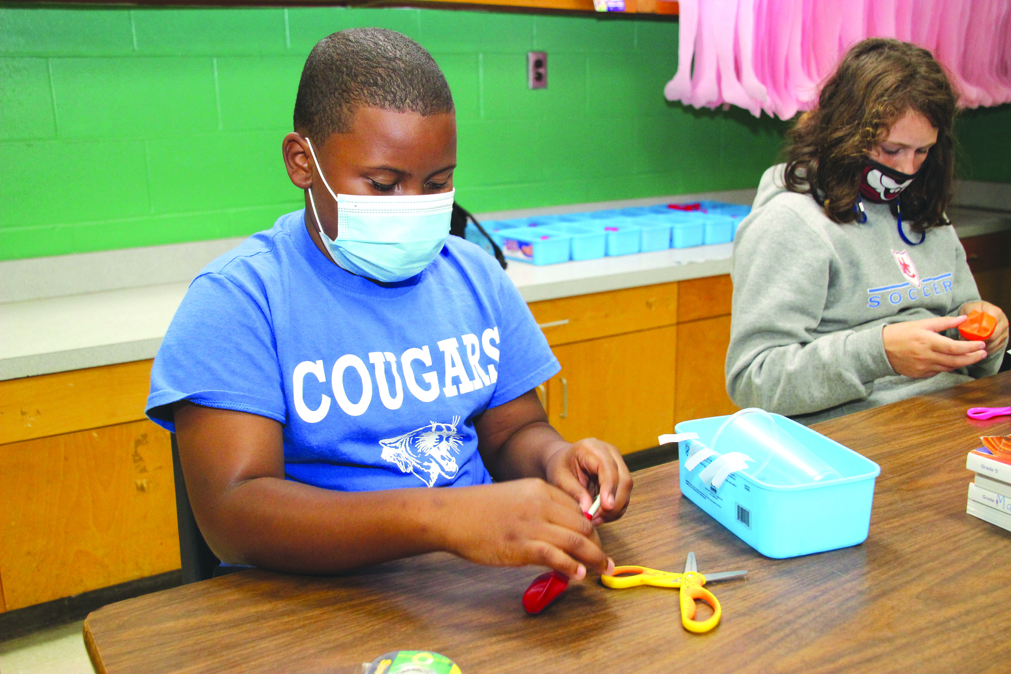 Fifth graders at Newton County Elementary School are researching Newton’s laws of motion during science lab activity rotation, with this week’s focus, “for every action, there is an equal and opposite reaction.” Students built a car powered by a balloon and tested it on the classroom track, from left:  Mychael Henson and Presleigh Wade.