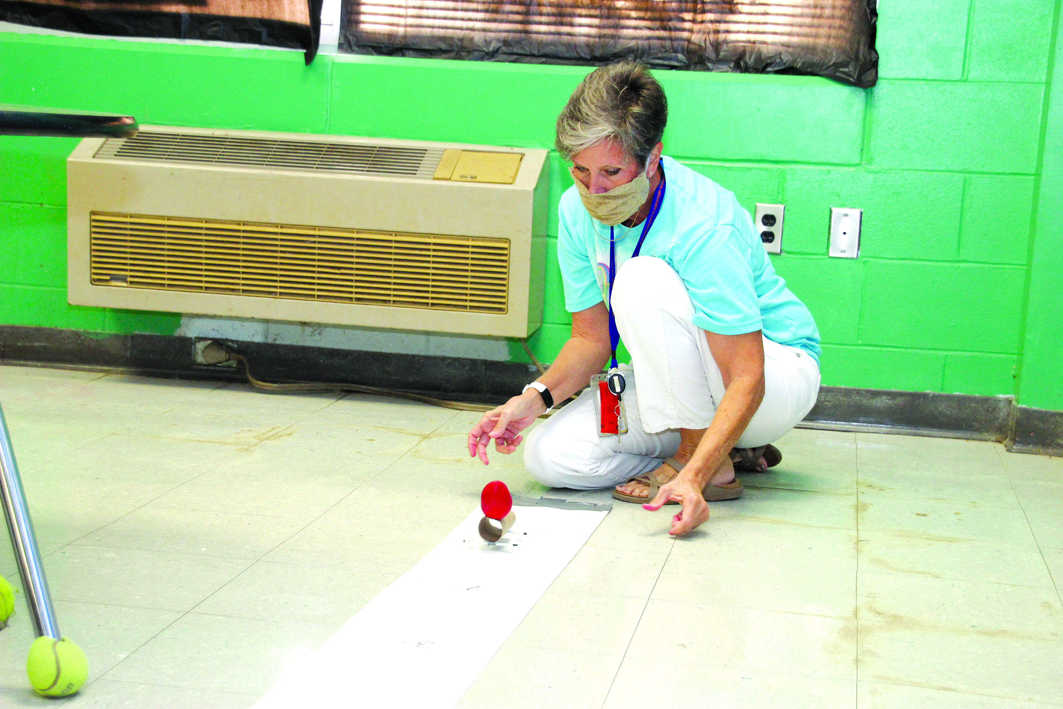 NCES Science Lab Instructor Paula Berryhill demonstrates a car on the test track. 