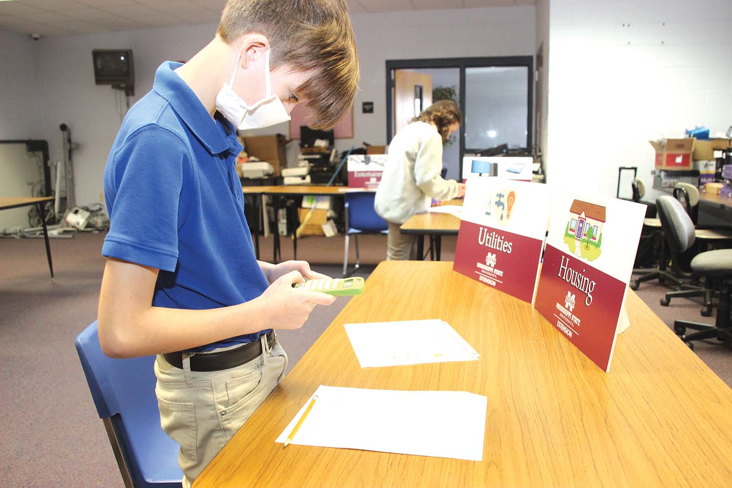 Kemper Hughes, a sixth grader at Newton County Middle School, calculates his projected utilities and housing costs during a simulation in Melisa Hill’s TAG class. Students were introduced to careers, salaries, taxes and expenses in order to make wise decisions and create a sustainable budget.   Submitted photo