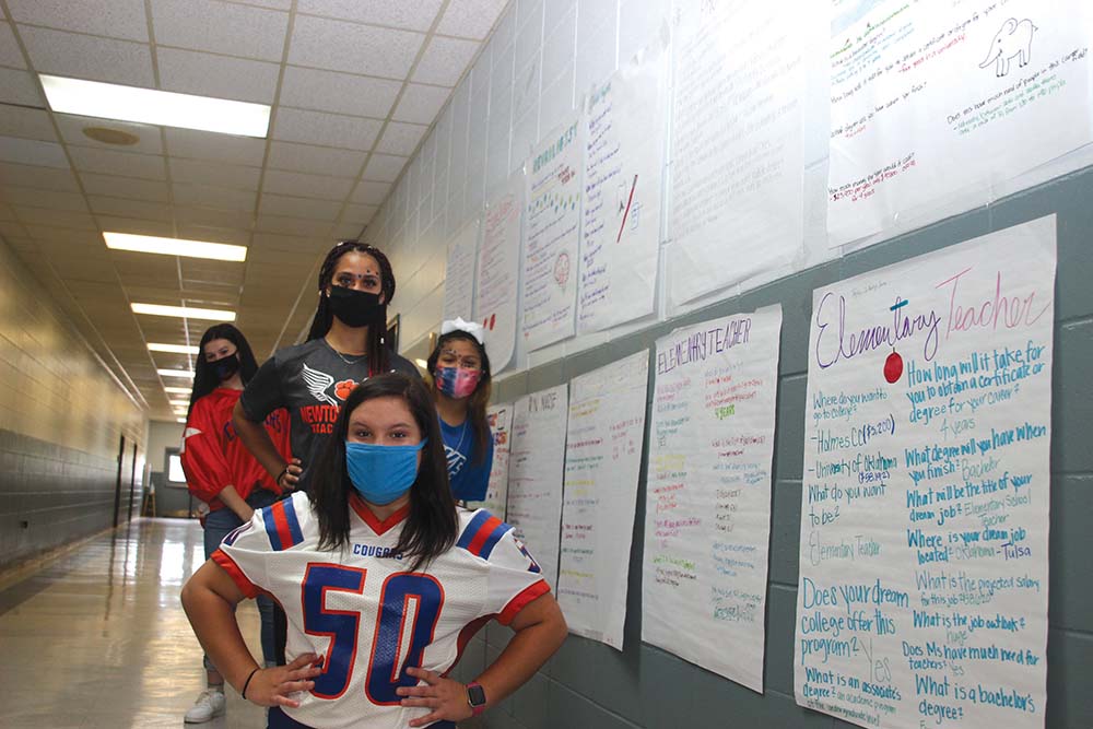 Brooklyn Mowdy, Hannah Reilly, Kaylynn Johnson, and Baley Cutway take a moment during Homecoming Week to check out the many job opportunities to consider on the Early Childhood Career Investigation Wall at the Newton County Career and Technical Center. Early Childhood students selected a career choice and researched the characteristics of each inclusive of education requirements and projected salaries. Michele Robinson is the NCCTC Early Childhood Instructor.    