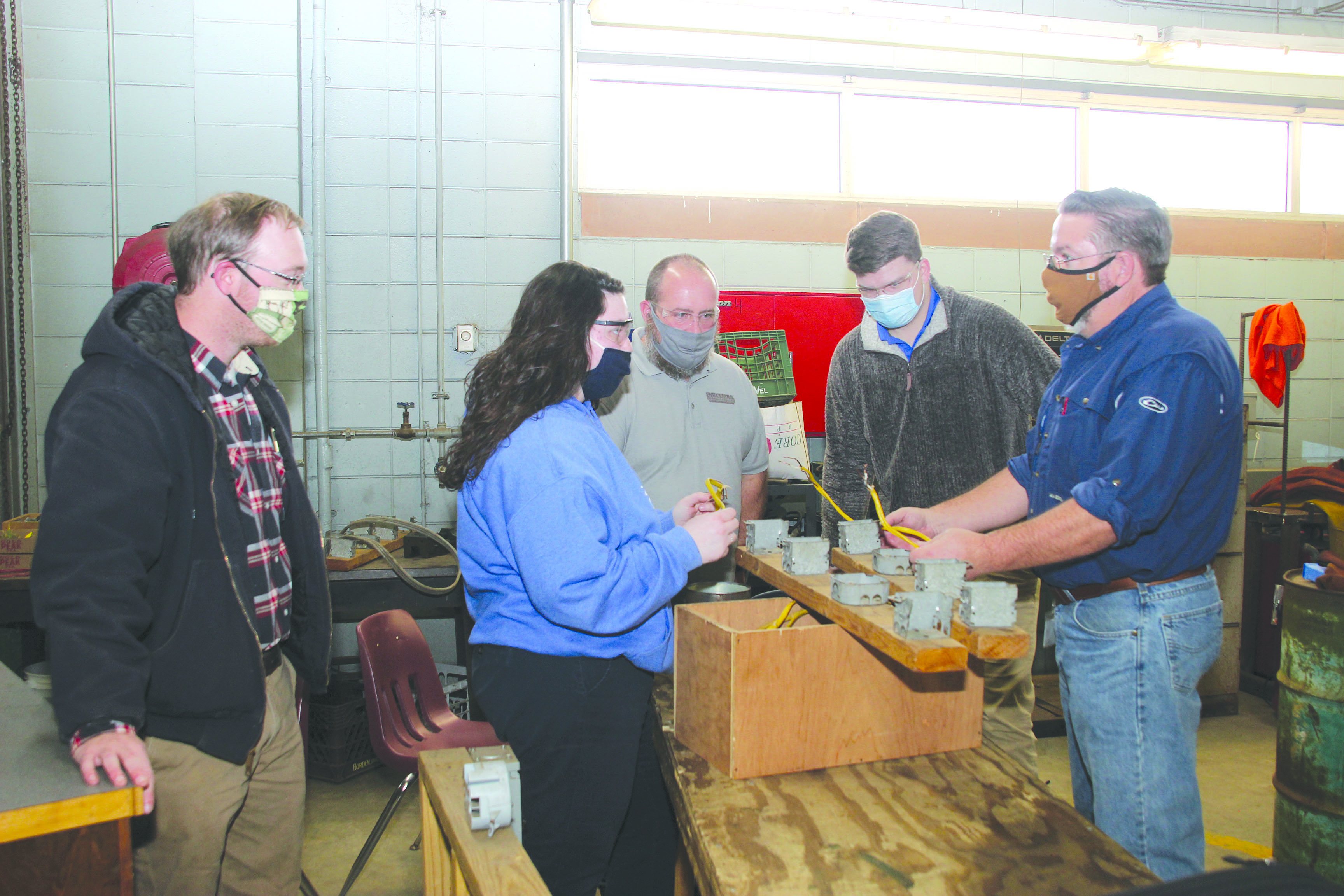 Newton County Career and Technical Center hosted program representatives from East Central Community College during CTE Awareness Month. NCCTC Agriculture and Natural Resources II and NCHS Seniors Bethany Chaney (second from left) and Austin Snow (second from right) listen attentively to a demonstration by East Central Community College Electrical Technology Instructor John Everett. Harold Hollingsworth, East Central Community College Heating and Air Conditioning Technology Instructor, also offered the students an introduction of his program at ECCC. Tyler Carroll (left) is the NCCTC Agriculture and Natural Resources Instructor. Submitted photo