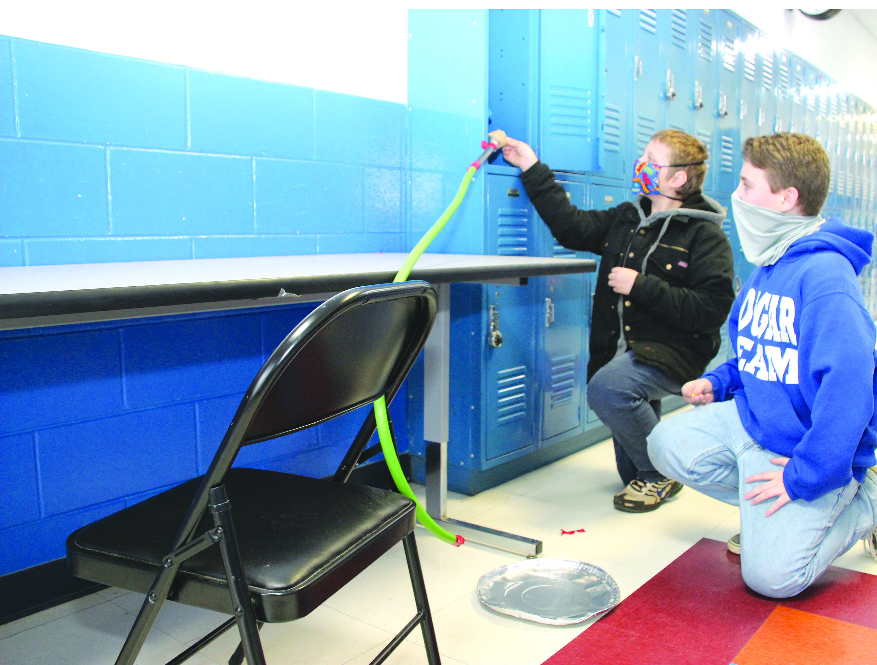 Newton County Middle School sixth grade Science students, Lily Walters and Madelyn Wayman, assess their slide and make adjustments, preparing to measure the distance and time to calculate the speed of a marble. Submitted photo