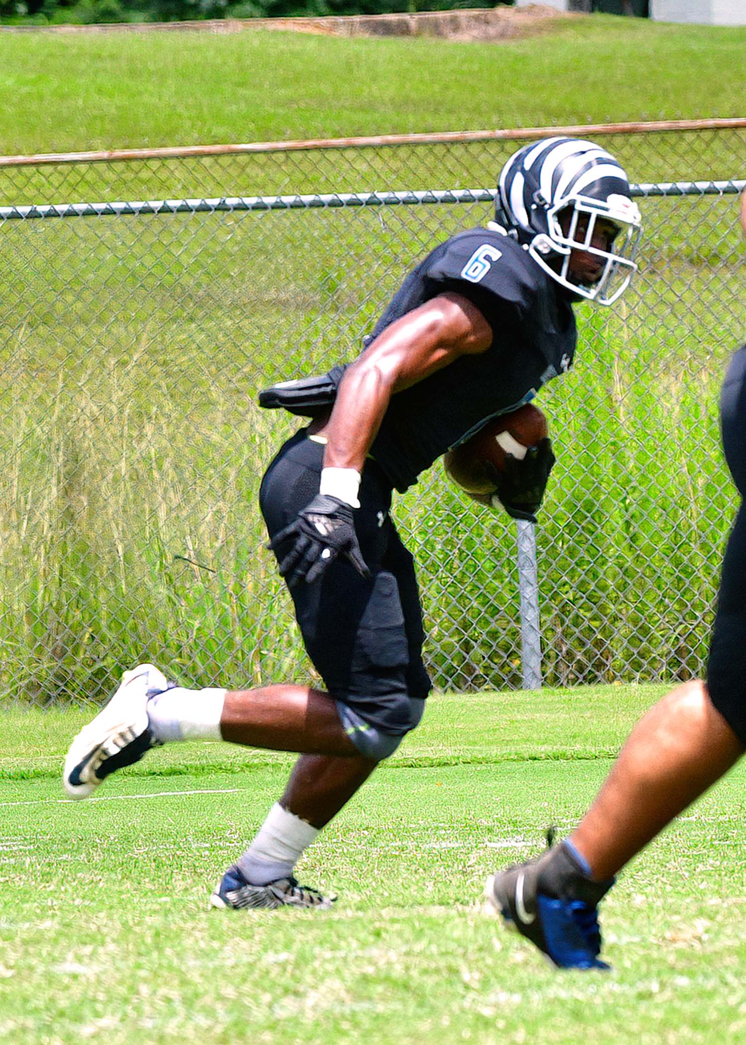 Newton’s Marquise Poole is shown above running the ball during a jamboree game. His funeral was held last week. Photographer Jeff Parks found this photo in his archive.