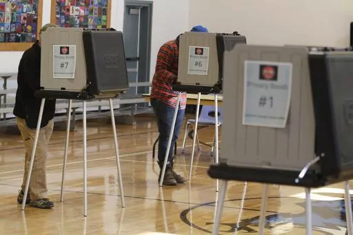 Voters fill out ballots at an elementary school in Tesuque, N.M., on Tuesday, Nov. 8, 2022. A federal judge has ruled, Tuesday, April 2, 2024, that New Mexico election regulators violated public disclosure provisions of the National Voter Registration Act in withholding voter rolls from a conservative group and its public online database. (AP Photo/Morgan Lee, File)