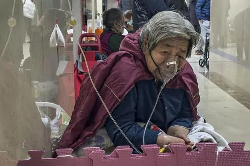An elderly patient receives an intravenous drip while using a ventilator in the hallway of the emergency ward in Beijing, Jan. 5, 2023. China's sudden reopening after two years holding to a "zero-COVID" strategy left older people vulnerable and hospitals and pharmacies unprepared during the season when the virus spreads most easily, leading to many avoidable deaths, The Associated Press has found. (AP Photo/Andy Wong, File)