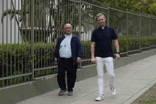 Vatican investigators Monsignor Jordi Bertomeu, right, from Spain, and Archbishop Charles Scicluna, from Malta, walk outside of the Nunciatura Apostolica during a break from meeting with people who alleged abuse by the Catholic lay group Sodalitium Christianae Vitae in Lima, Peru, on July 25, 2023. (AP Photo/Martin Mejia, File)