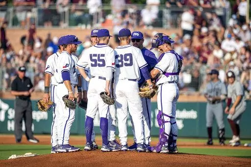 TCU baseball coach Kirk Saarloos meets on the mound with pitcher Austin Krob (39) and the TCU infield during an NCAA college baseball tournament regional game against Texas A&M, Sunday, June 5, 2022, in College Station, Texas. TCU had the best weekend as college baseball season opened with wins over top-10 opponents Vanderbilt and Arkansas. (Meredith Seaver/College Station Eagle via AP, File)