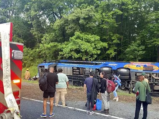This image provided by the Baltimore County Fire Department shows the scene of a Megabus crash on I-95 south near Kingsville, Md., Sunday, May 22, 2022. The vehicle was carrying 47 people. Officials said that 15 of the 27 people injured were taken to local hospitals. (Baltimore County Fire Department via AP)