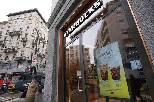 A Starbucks sign advertises the company's Oleato coffee in one of their coffee shops in Milan, Italy, Monday, Feb. 27, 2023. Putting olive oil in coffee is hardly a tradition in Italy, but that didn't stop Starbucks founder and CEO Howard Schultz from launching a series of beverages doing just that in Milan, the city that inspired his coffee house empire. (AP Photo/Antonio Calanni)