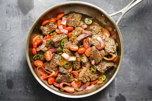 This image released by Milk Street shows a recipe for Lomo Saltado. (Milk Street via AP)
