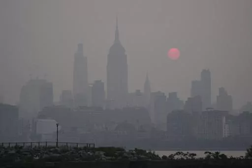 The sun rises over a hazy New York City skyline as seen from Jersey City, N.J., Wednesday, June 7, 2023. (AP Photo/Seth Wenig)