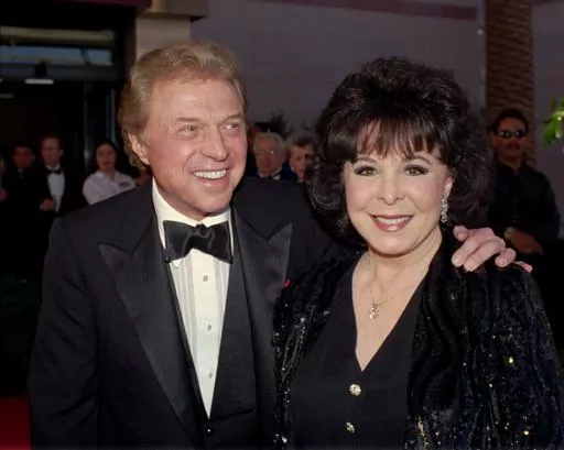 Singer Steve Lawrence, left, and his wife Eydie Gorme arrive at a black-tie gala called honoring Frank Sinatra in Las Vegas on May 30, 1998. Lawrence, a singer and top stage act who as a solo performer and in tandem with his wife Gorme kept Tin Pan Alley alive during the rock era, died Wednesday, March 6, 2024 at age 88. Gorme died on Aug. 10, 2013. (AP Photo/Lennox McLendon, File)