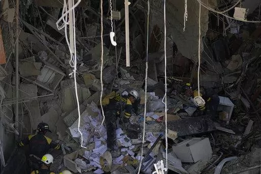 Rescuers search for survivors at the site of Friday's deadly explosion that destroyed the five-star Hotel Saratoga, in Havana, Cuba, Saturday, May 7, 2022. (AP Photo/Ramon Espinosa)