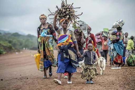 Residents flee fighting between M23 rebels and Congolese forces near Kibumba, some 20 kms ( 12 miles) North of Goma, Democratic Republic of Congo, on Oct. 29, 2022. A senior UN official said Tuesday, Sept. 5, 2023, the humanitarian situation in conflict-wracked eastern Congo has deteriorated alarmingly in the past 18 months with 8 million people in urgent need of assistance and women and girls subjected to sexual violence on a massive scale -- just in three provinces. (AP Photo/Moses Sawasawa, F