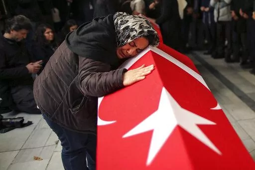 Relatives and friends of Arzu Ozsoy and her 15-year-old daughter Yagmur Ucar, who died in Sunday's explosion occurred on Istiklal avenue, attend their funeral in Istanbul, Turkey, Monday, Nov. 14, 2022. Turkish police said Monday that they have detained a Syrian woman with suspected links to Kurdish militants and that she confessed to planting a bomb that exploded on a bustling pedestrian avenue in Istanbul, killing six people and wounding several dozen others. (AP Photo/Emrah Gurel)