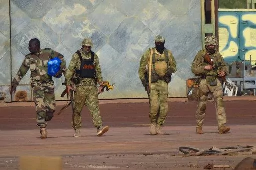 This undated photograph handed out by French military shows three Russian mercenaries, right, in northern Mali. Western officials say violence against civilians in Mali has risen in the year since hundreds of Russian mercenaries have started working alongside the West African country's armed forces to stem a decade-long insurgency by Islamic extremists. Diplomats, analysts and human rights groups say extremists linked to al-Qaida and the Islamic State group have only gotten stronger and there's 
