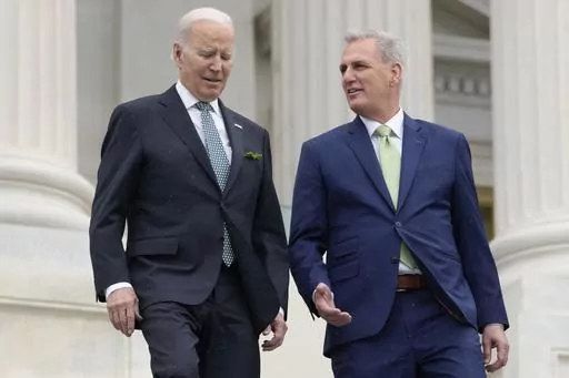 President Joe Biden talks with House Speaker Kevin McCarthy of Calif., as they walk down the House steps as they leave after attending an annual St. Patrick's Day luncheon gathering at the Capitol in Washington, March 17, 2023. The Tuesday, May 9, White House sitdown between the president and congressional leaders will be the first substantive talks between Biden and McCarthy in months, and comes weeks after House Republicans voted on a bill that would raise the debt limit but impose significant