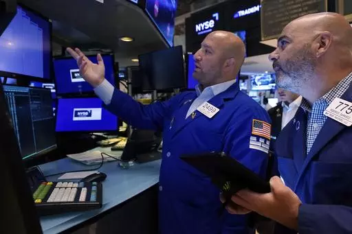 Specialist John Parisi, left, and trader Fred DeMarco work on the floor of the New York Stock Exchange, Wednesday, Aug. 23, 2023. Wall Street is drifting Wednesday ahead of a profit report that could show whether the frenzy this year around artificial-intelligence technology is deserved or overdone. (AP Photo/Richard Drew)