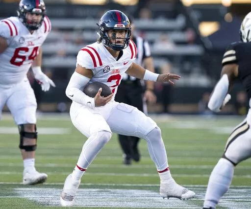 Mississippi quarterback Jaxson Dart (2) scrambles past the Vanderbilt defense during the third quarter of an NCAA college football game Saturday, Oct. 8, 2022, in Nashville, Tenn. (George Walker IV/The Tennessean via AP)