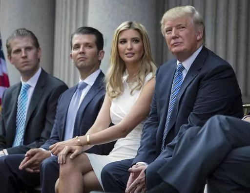Donald Trump, right, sits with his children, from left, Eric Trump, Donald Trump Jr., and Ivanka Trump during a groundbreaking ceremony for the Trump International Hotel on July 23, 2014, in Washington. A New York appeals court dismissed Ivanka Trump on Tuesday, June 27, 2023, from a wide-ranging fraud lawsuit brought against her father and his company last year by the state's attorney general. (AP Photo/Evan Vucci, File)