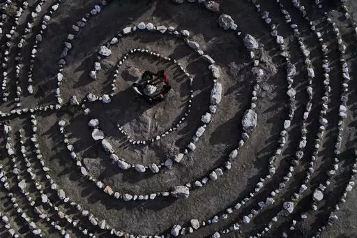 A group of Brazilian tourists hold hands standing in a circle at the heart of a stone labyrinth in the Pueblo Encanto spiritual theme park in Capilla del Monte, Argentina, Wednesday, July 19, 2023. In the pope’s homeland of Argentina, Catholics have been renouncing the faith and joining the growing ranks of the religiously unaffiliated. Commonly known as the “nones,” they describe themselves as atheists, agnostics, spiritual but not religious, or simply: “nothing in particular.” (AP Ph
