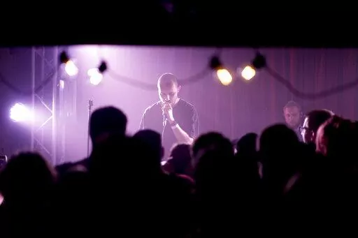 Viacheslav Drofa, known as Otoy, performs during a concert to raise funds for soldiers fighting for Ukraine in Kyiv, Ukraine, Sunday, June 5, 2022. From the battlefronts of Ukraine comes rap music — filled with the anger and indignation of a young generation that, once the fighting is done, will certainly never forget and may never forgive.Ukrainian rapper-turned-volunteer soldier Otoy is putting the war into words and thumping baselines, tapping out lyrics under Russian shelling on his phone,