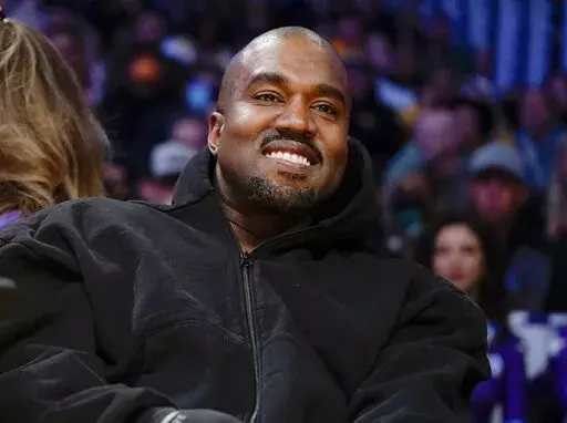 Kanye West watches the first half of an NBA basketball game between the Washington Wizards and the Los Angeles Lakers in Los Angeles, on March 11, 2022 A completed documentary about the rapper formerly known as Kanye West has been shelved amid his recent slew of antisemitic remarks.. (AP Photo/Ashley Landis, File)