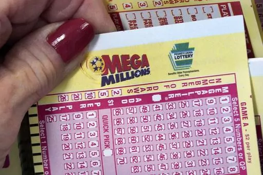 A Mega Millions wagering slip is held in Cranberry Township, Pa., Jan. 12, 2023. The Mega Millions top prize has jumped to an estimated $820 million after there was no grand prize winner in the latest drawing, late Friday, July 21, 2023. (AP Photo/Gene J. Puskar, File)