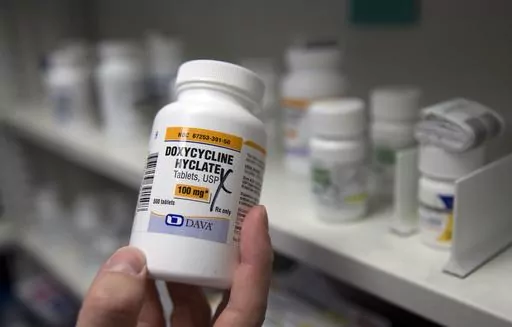 A pharmacist holds a bottle of the antibiotic doxycycline hyclate in Sacramento, Calif., July 8, 2016. The Centers for Disease Control and Prevention announced Monday, Oct. 2, 2023, that it plans to endorse the antibiotic as a post-sex morning after pill that gay and bisexual men can use to avoid some increasingly common sexually transmitted diseases. (AP Photo/Rich Pedroncelli, File)