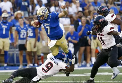 Tulsa quarterback Davis Brin tries to get away from Northern Illinois' Daveren Rayner during an NCAA college football game Saturday, Sept. 10, 2022, in Tulsa, Okla. (Stephen Pingry/Tulsa World via AP)