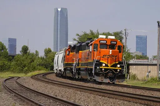 A BNSF locomotive heads south out of Oklahoma City, Wednesday, Sept. 14, 2022. A fifth rail union has approved its deal with the freight railroads to secure 24% raises and $5,000 in bonuses and a sixth one is set to vote Thursday. But all 12 rail unions must ratify their contracts to prevent a strike. (AP Photo/Sue Ogrocki, File)