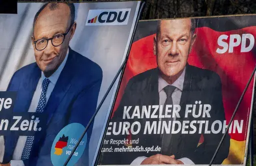 Election posters showing German Chancellor Olaf Scholz, right, and CDU top candidate for chancellor Friedrich Merz in Frankfurt, Germany, Feb. 8, 2025. (AP Photo/Michael Probst, File)