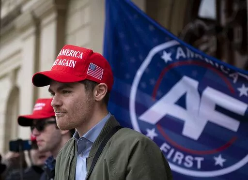 Nick Fuentes, far-right activist, holds a rally at the Lansing Capitol, in Lansing, Mich., Nov. 11, 2020. Former President Donald Trump had dinner Tuesday, Nov. 22, 2022, at his Mar-a-Lago club with the rapper formerly known as Kanye West, who is now known as Ye, as well as Nick Fuentes, who has used his online platform to spew antisemitic and white supremacist rhetoric. (Nicole Hester/Ann Arbor News via AP, File)