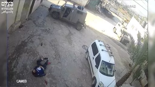 This image taken from video taken on Dec 8, 2023, in the Faraa refuge camp shows soldiers shooting down the men at close range when they did not appear to pose a threat. Security footage obtained by the Israeli human rights group B'Tselem shows two Israeli soldiers pursuing shooting the men — one while he was incapacitated and the other appearing to be unarmed — during a raid in a West Bank refugee camp. (B'Tselem via AP)