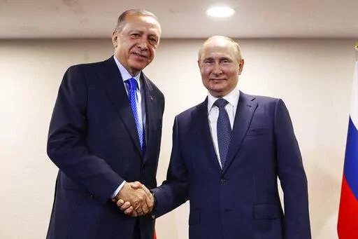 In this handout photo provided by the Turkish Presidency, Turkish President Recep Tayyip Erdogan, left, shakes hands with Russian President Vladimir Putin during their meeting, in Tehran, Iran, July 19, 2022. The Biden administration likes to say that Russia is now isolated internationally because of its invasion of Ukraine. Yet its top officials are hardly sitting lonely and isolated in the Kremlin and now the U.S. wants to talk.(Turkish Presidency via AP, File)
