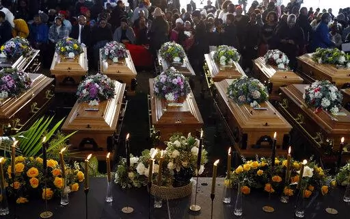 A  view of the coffins during a funeral service held in Scenery Park, East London, South Africa, Wednesday, July 6, 2022. More than a thousand grieving family and community members are attending the funeral in South Africa's East London for 21 teenagers who died in a mysterious tragedy at a nightclub nearly two weeks ago. South African President Cyril Ramaphosa is due to give the eulogy for the young who died. (AP Photo)