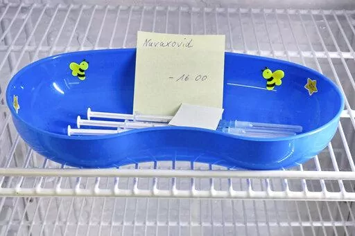 A kidney dish with syringes containing the Novavax COVID-19 vaccine sits in a refrigerator ready for use at a vaccination center in Prisdorf, Germany, Saturday, Feb. 26, 2022. On Tuesday, July 19, 2022, a U.S. Centers for Disease Control and Prevention advisory panel recommended the shots and final action will come from the agency's director. (Georg Wendt/dpa via AP, File)