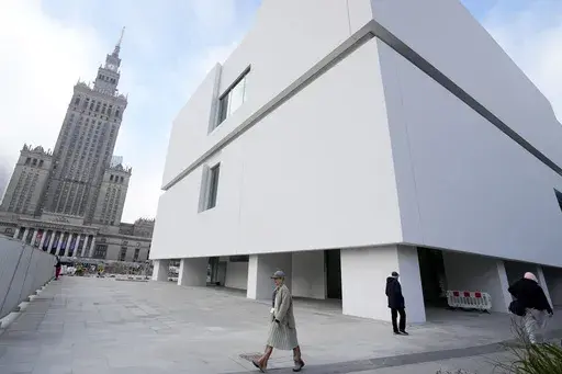 People walk outside the Museum of Modern Art in Warsaw, Poland, on Thursday Oct. 24, 2024. (AP Photo/Czarek Sokolowski)