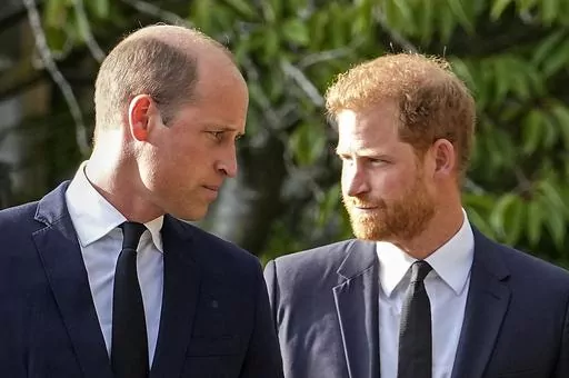 Britain's Prince William and Britain's Prince Harry walk beside each other after viewing the floral tributes for the late Queen Elizabeth II outside Windsor Castle, in Windsor, England, Saturday, Sept. 10, 2022. Court papers say that Prince William quietly received “a very large sum of money” in a 2020 phone hacking settlement with the British newspaper arm of Rupert Murdoch’s media empire. Court documents aired Tuesday in one of his brother's lawsuits against British newspapers says the P
