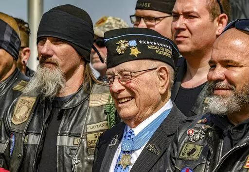 Hershel "Woody" Williams, center, the sole surviving U.S. Marine to be awarded the Medal of Honor during World War II, poses with fellow Marines at the Charles E. Shelton Freedom Memorial at Smothers Park, Saturday, April 6, 2019, in Owensboro, Ky. Williams, the last remaining Medal of Honor recipient from World War II, died Wednesday, June 29, 2022 He was 98. Williams' foundation announced on Twitter and Facebook that he died at the Veterans Affairs medical center bearing his name in Huntington