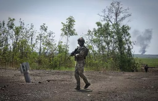 Ukrainian soldiers walk in their positions on the frontline in Zaporizhzhia region, Ukraine, Friday, June 23, 2023. In the southeastern Zaporizhzhia region, Ukrainian troops - backed by tanks, artillery and drones - have broken through initial Russian fighting positions and continue to make steady gains south of Velyka Novosilka near the administrative border with Donestk and south of Orikhiv, while confronting heavy bombardment in wide open fields with little cover. (AP Photo/Efrem Lukatsky, Fi