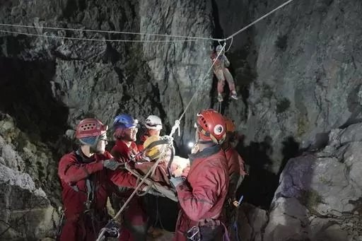 In this photo released by Turkish government's Search and Rescue agency AFAD, American researcher Mark Dickey, center, is pulled out of Morca cave near Anamur, south Turkey, on early Tuesday, Sept. 12, 2023, more than a week after he became seriously ill 1,000 meters (more than 3,000 feet) below its entrance. Teams from across Europe had rushed to Morca cave in southern Turkey's Taurus Mountains to aid Dickey, a 40-year-old experienced caver who became seriously ill on Sept. 2 with stomach bleed
