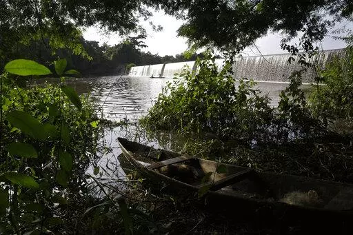 A fishing canoe sits near a dam that sources the sacred Osun River in Esa-Odo, Nigeria, on Saturday, May 28, 2022. The river, which flows through the dense forest of the Osun-Osogbo Sacred Grove — designated a UNESCO World Heritage Site in 2005 — is revered for its cultural and religious significance among the Yoruba-speaking people predominant in southwestern Nigeria, where the goddess Osun is widely worshipped. (AP Photo/Sunday Alamba)