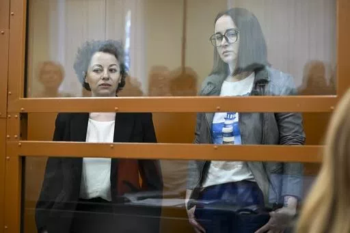 Theater director Zhenya Berkovich, left, and playwright Svetlana Petriychuk are seen in a glass cage prior to a hearing in a court in Moscow, Russia, Monday, May 20, 2024. Berkovich, a prominent independent theater director, and Petriychuk, a playwright have been behind bars since early May. Authorities claim a play they staged, "Finist, the Brave Falcon," justifies terrorism, which is a criminal offence in Russia punishable by up to seven years in prison. (AP Photo/Dmitry Serebryakov)